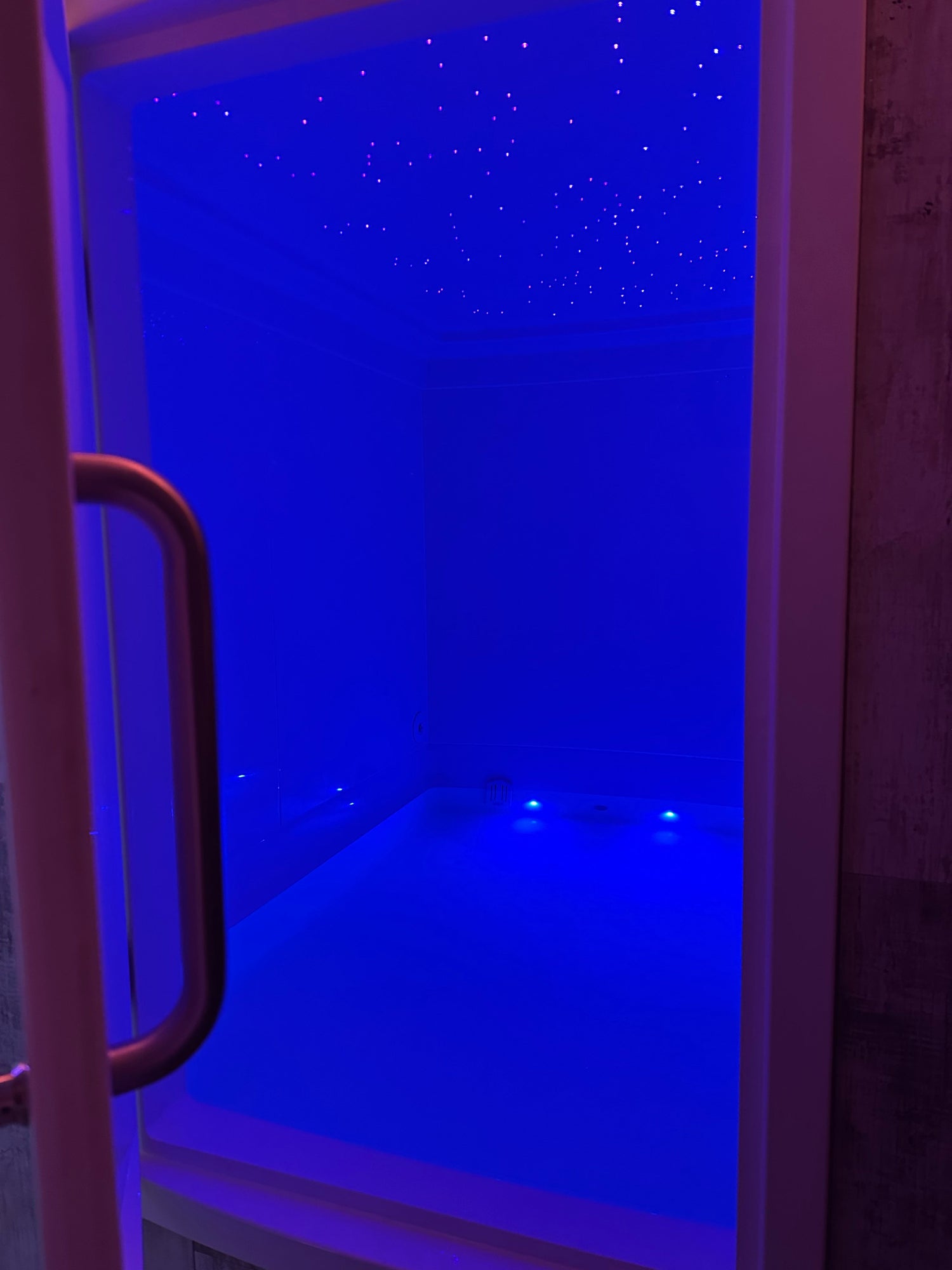 A quiet, softly lit float room at Revival, set up for an hour of undisturbed rest